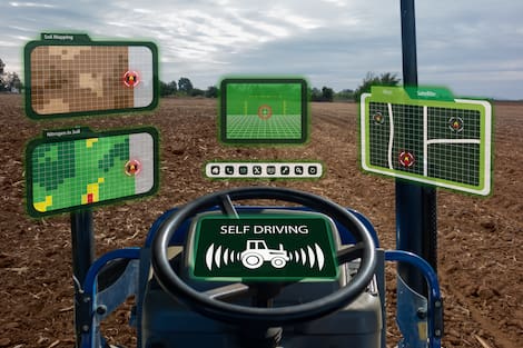 Máquina agrícola operada com piloto automático, e com vários indicadores da operação sendo apresentados por monitores em tempo real 